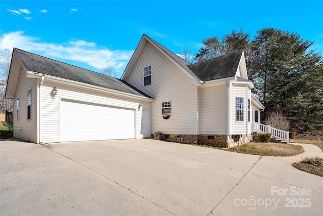 view of side of home featuring a garage