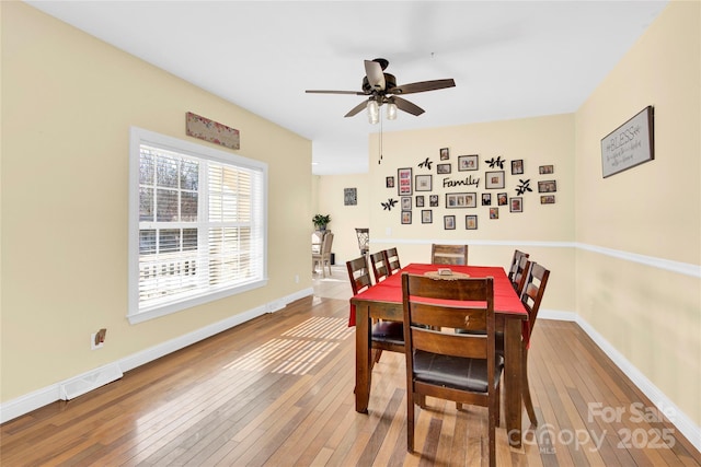 dining area with ceiling fan and hardwood / wood-style floors