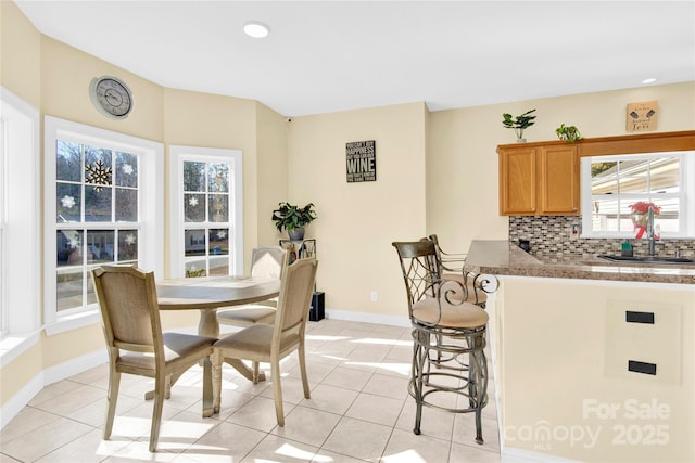 tiled dining room with sink