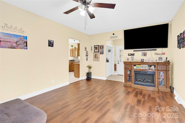 living room featuring hardwood / wood-style flooring and ceiling fan