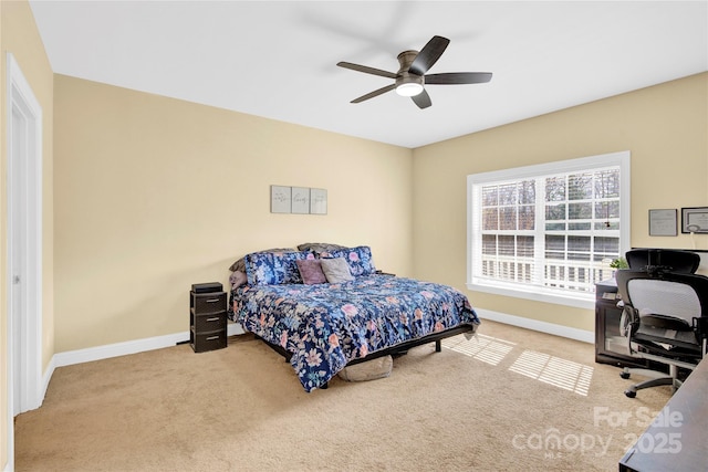 bedroom featuring light carpet and ceiling fan