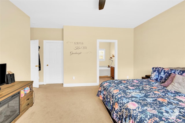 carpeted bedroom with ceiling fan and connected bathroom