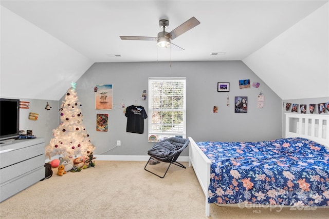 bedroom with ceiling fan, vaulted ceiling, and carpet