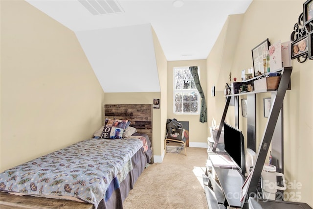 bedroom with vaulted ceiling and light carpet