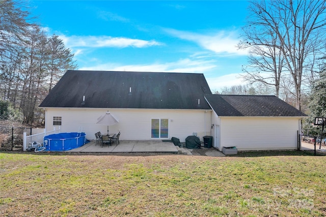 rear view of property with a yard and a patio