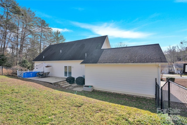 rear view of house featuring a yard and a patio area