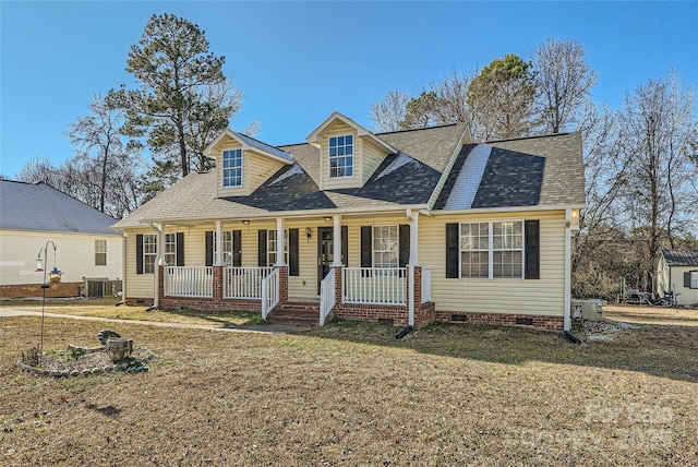 cape cod-style house with covered porch, central AC, and a front lawn