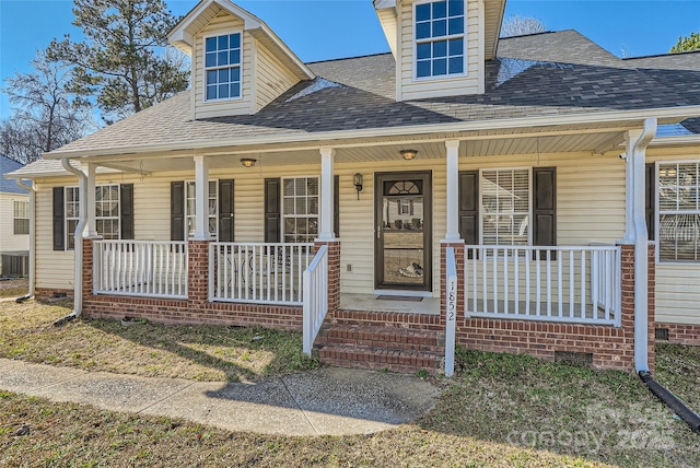 view of front of home with a porch and central AC