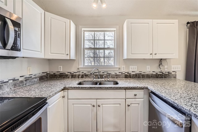 kitchen featuring sink, white cabinetry, and appliances with stainless steel finishes