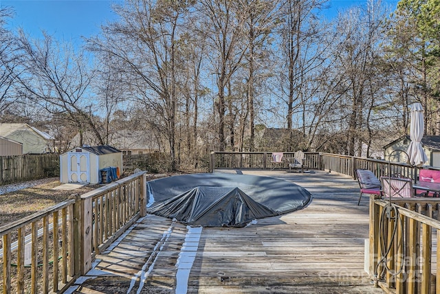 wooden terrace featuring a storage shed