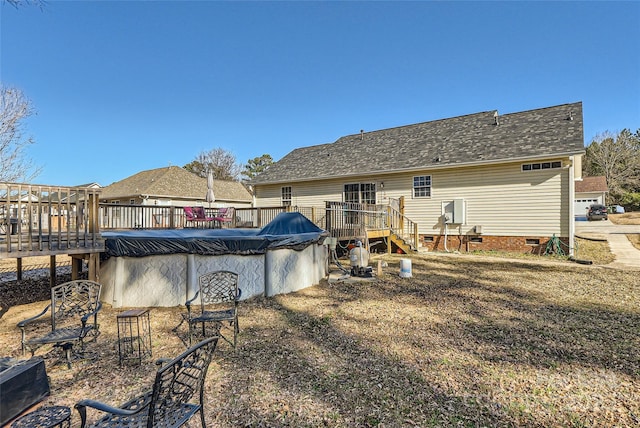 rear view of property with a swimming pool side deck