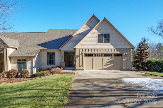 craftsman house featuring a garage and a front yard