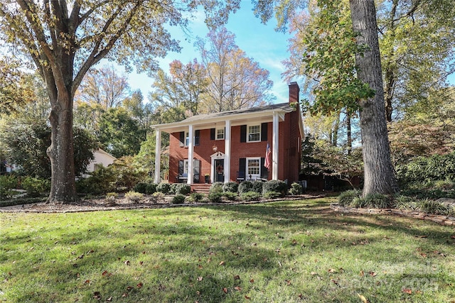 greek revival house with a front yard