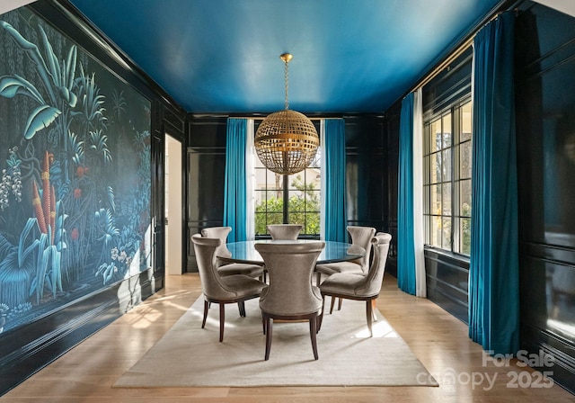 dining space with wood-type flooring and a chandelier