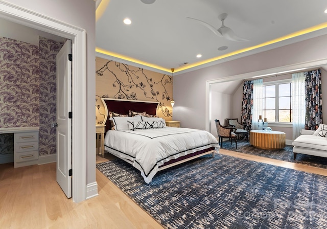 bedroom featuring wood-type flooring and a tray ceiling