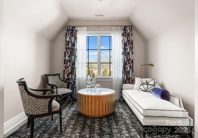 sitting room featuring vaulted ceiling