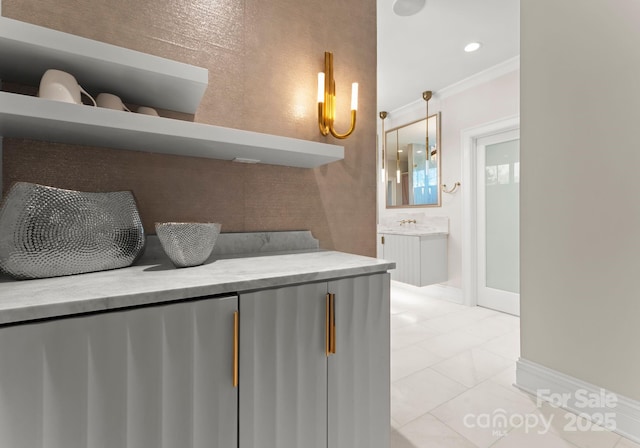 interior space with vanity, tile patterned flooring, and crown molding