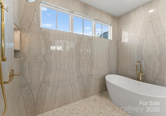 bathroom featuring tile walls and a tub