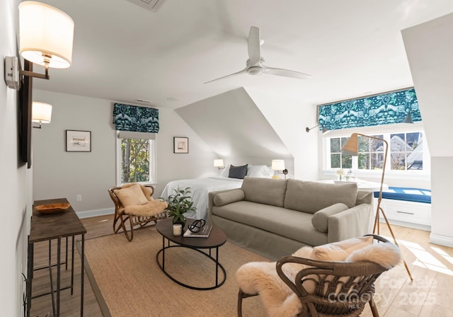 living room with light hardwood / wood-style floors and ceiling fan