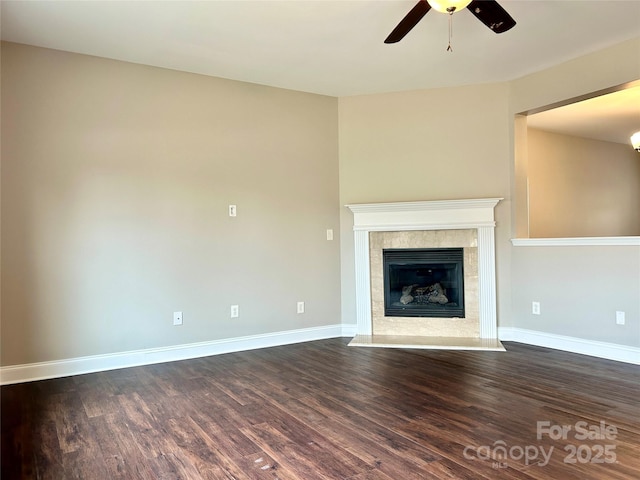 unfurnished living room with a fireplace, dark wood finished floors, and baseboards