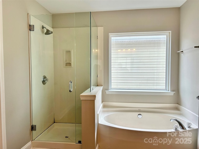 full bathroom with a stall shower and a garden tub