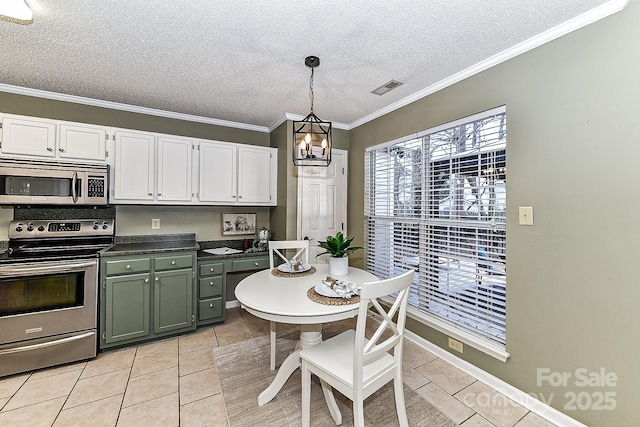 kitchen featuring appliances with stainless steel finishes, decorative light fixtures, white cabinetry, light tile patterned floors, and a textured ceiling