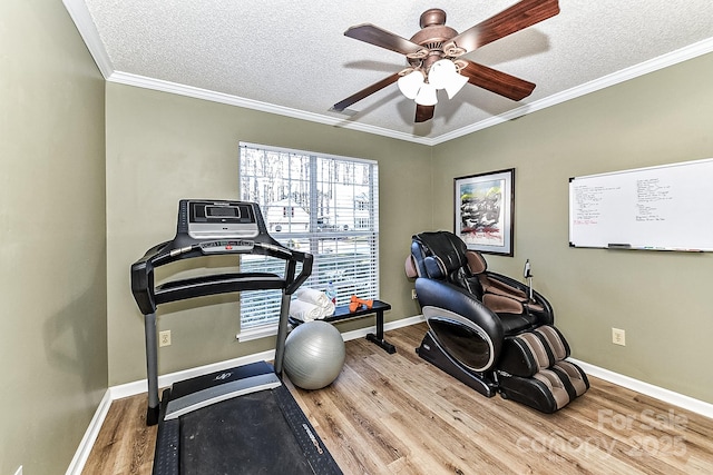 workout room with crown molding, hardwood / wood-style flooring, a textured ceiling, and ceiling fan