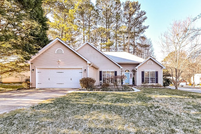 ranch-style house featuring a garage and a front yard