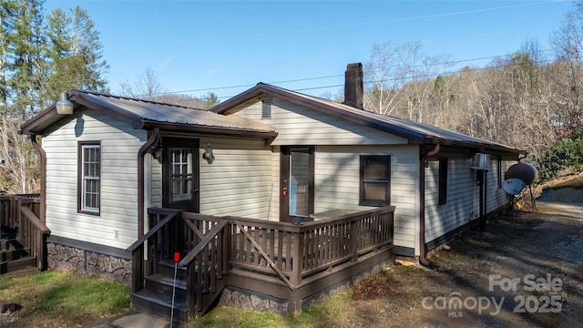 rear view of house with a wooden deck