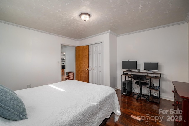 bedroom featuring ornamental molding, a closet, a textured ceiling, and dark hardwood / wood-style flooring