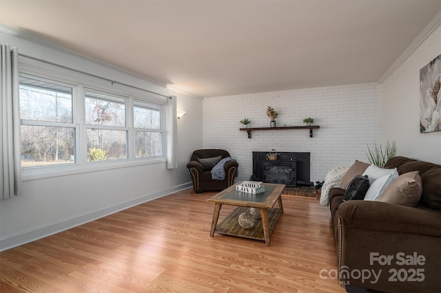 living room with light hardwood / wood-style flooring and ornamental molding