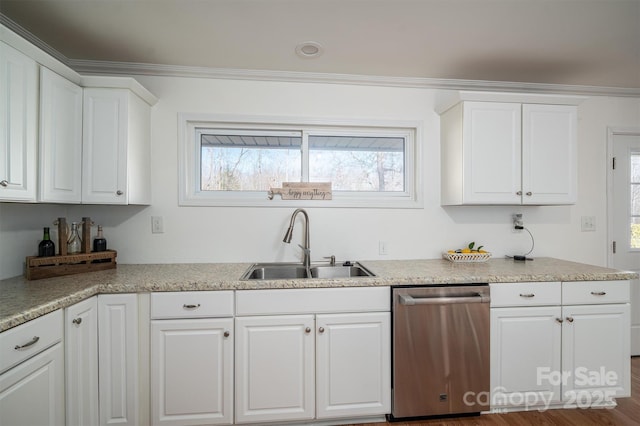 kitchen with dishwasher, light stone counters, crown molding, sink, and white cabinetry