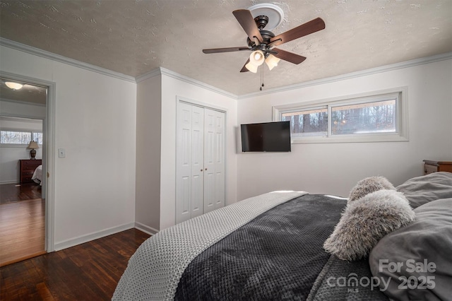 bedroom with dark hardwood / wood-style floors, a textured ceiling, a closet, and ornamental molding