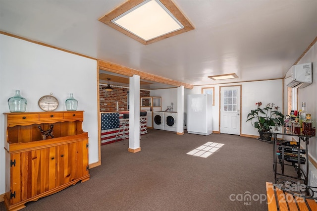 interior space featuring dark carpet, a wall mounted air conditioner, and washing machine and clothes dryer