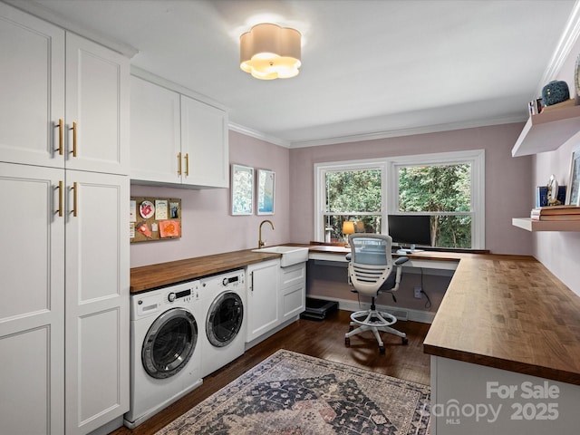 clothes washing area with sink, separate washer and dryer, ornamental molding, and cabinets