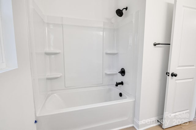 bathroom featuring hardwood / wood-style floors and shower / bathing tub combination