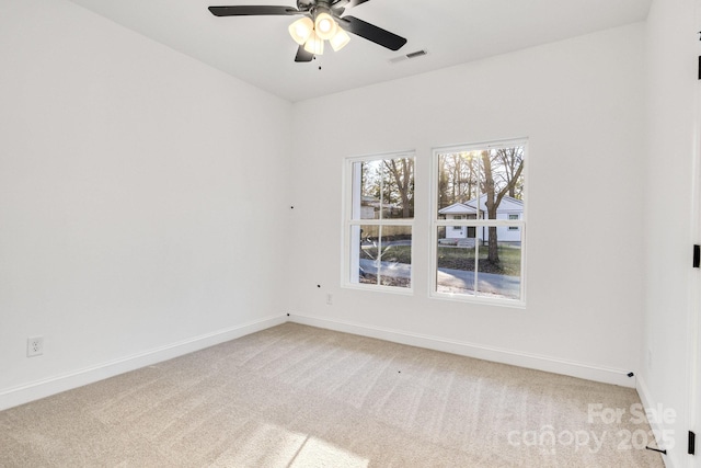 spare room with ceiling fan and carpet floors