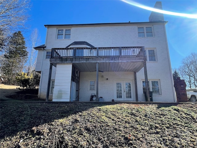 back of house featuring french doors and a deck