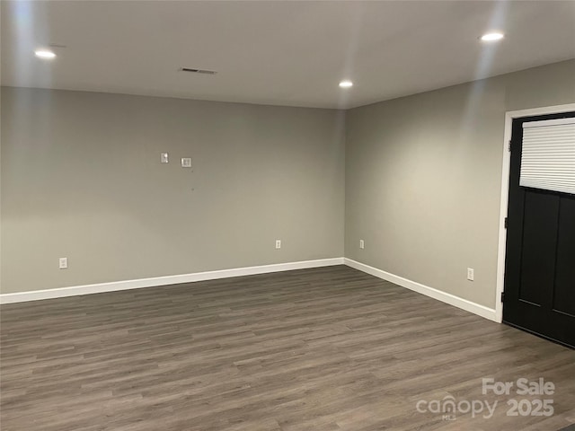 spare room with dark wood-type flooring