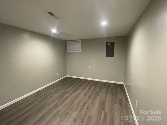 basement with electric panel and dark hardwood / wood-style floors