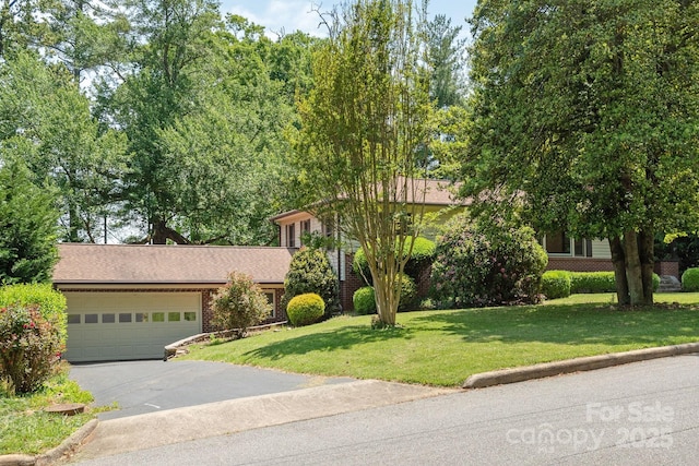 view of front of house featuring a garage and a front lawn