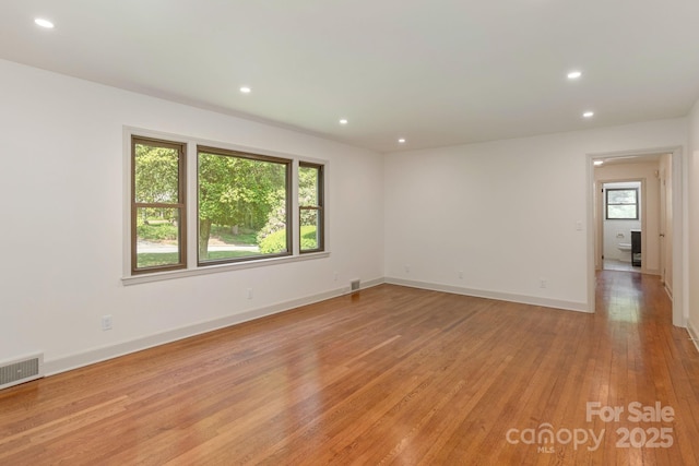 unfurnished room with light wood-type flooring