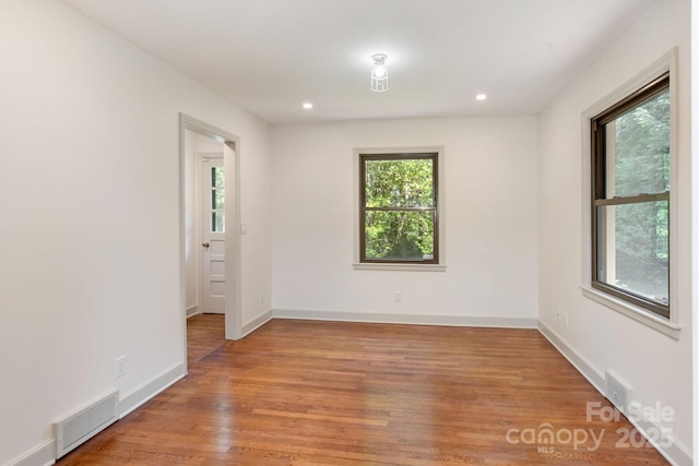 spare room featuring hardwood / wood-style floors