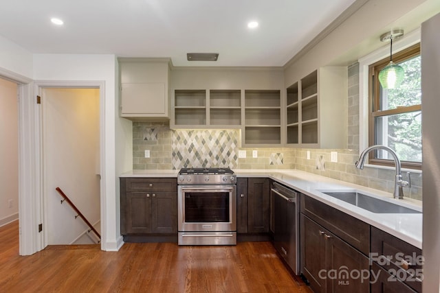 kitchen featuring pendant lighting, sink, dark hardwood / wood-style flooring, and appliances with stainless steel finishes