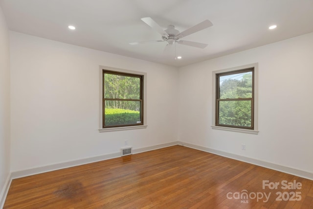 unfurnished room with hardwood / wood-style flooring and ceiling fan