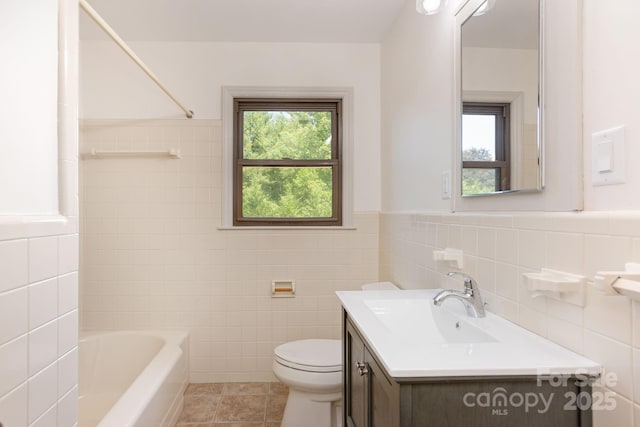 full bathroom featuring vanity, toilet, tile patterned flooring, and a wealth of natural light