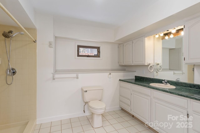 bathroom featuring vanity, tile patterned floors, toilet, and tiled shower