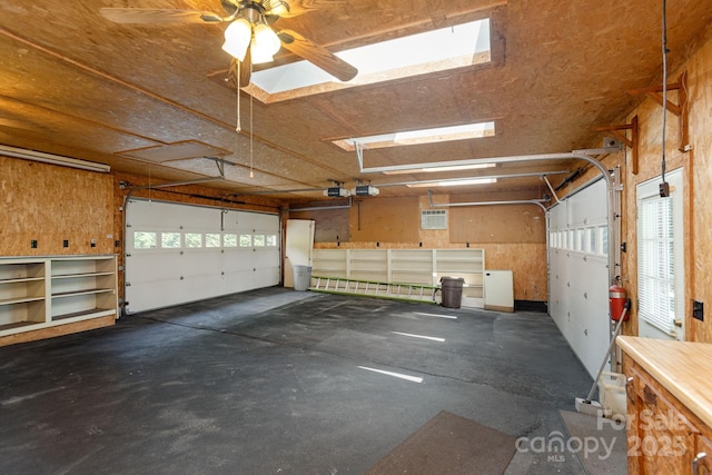 garage featuring ceiling fan and a garage door opener