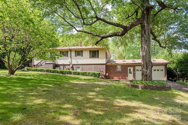 view of front of property with a garage and a front yard