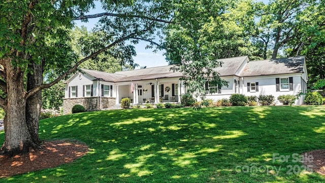 ranch-style home with a porch and a front yard